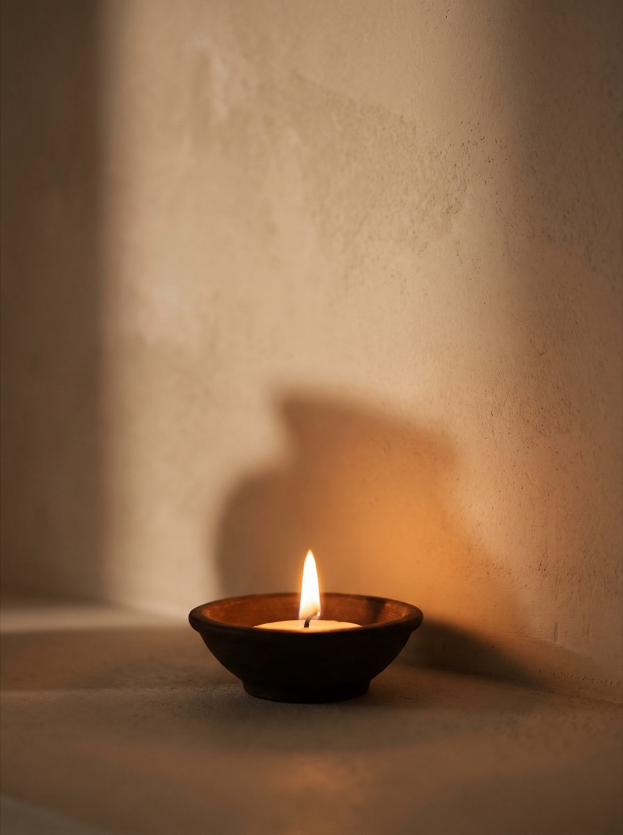 A small flame in a clay dish