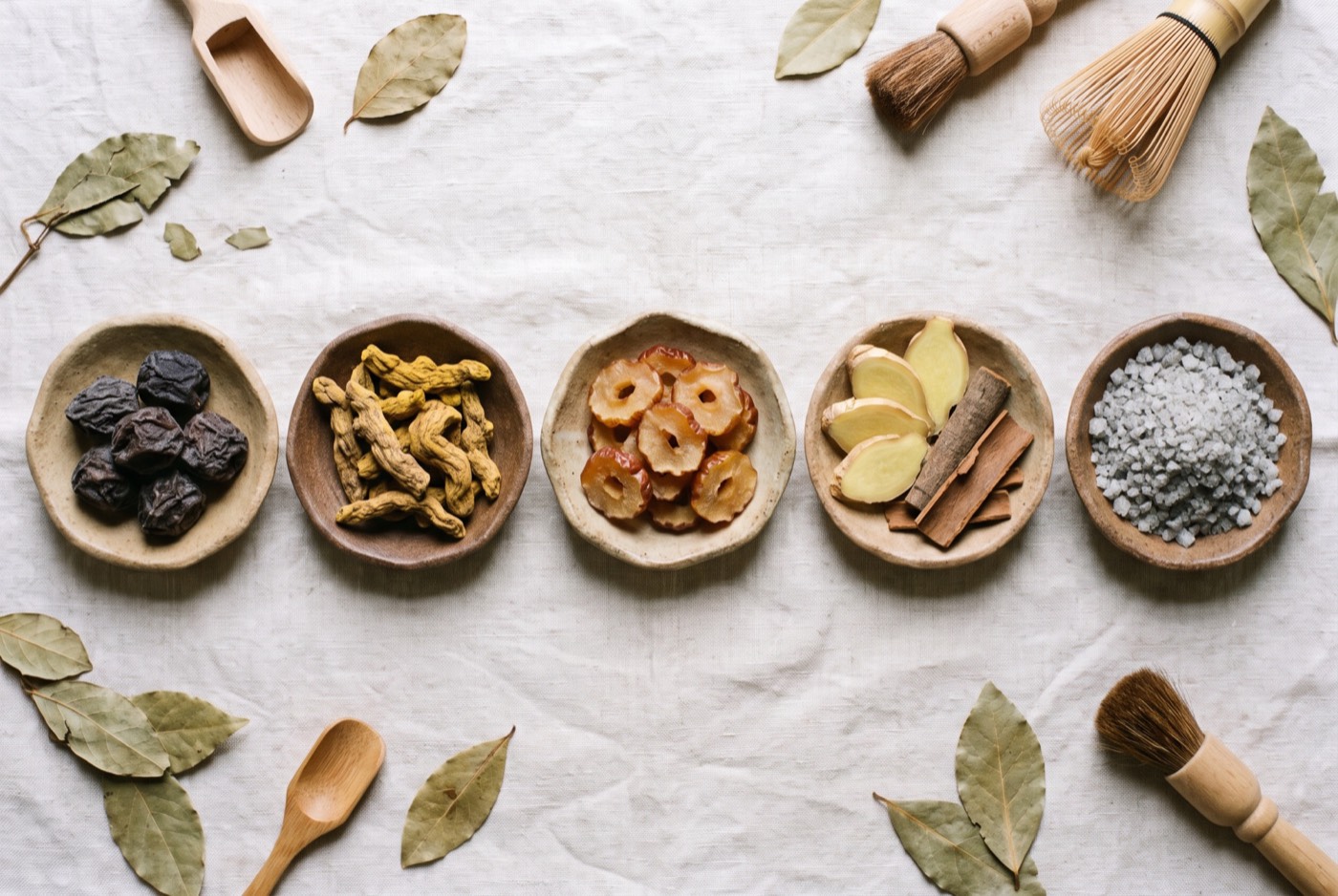 Five ceramic dishes: sour plum, bitter root, jujube, ginger and cinnamon, sea salt
